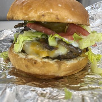 Western burger with lettuce tomato pickle and cheese 