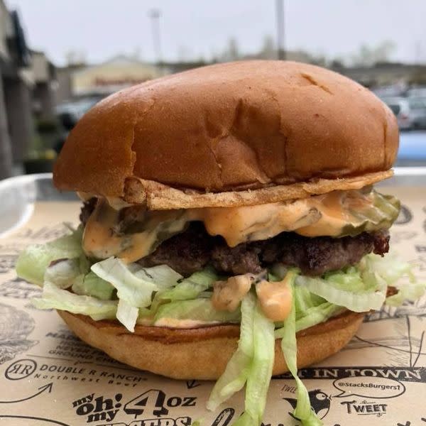 The Stack Burger comes with Premium Beef, American Cheese, Stack Sauce, Caramelized Onions, Shredded Lettuce, Pickles. Includes a side of fries