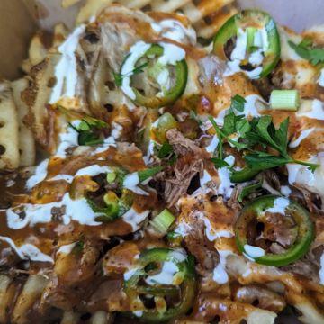 Loaded Freedom Fries (Waffle Fries with Birria, Muenster, Jalapenos, Sauces and more))