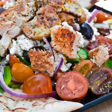 Greek salad with Chicken Gyros on top