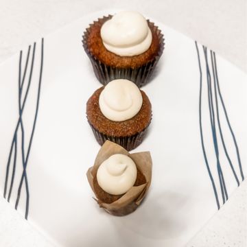 Standard size carrot cake muffin with cream cheese frosting
